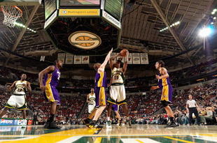 SEATTLE - FEBRUARY 24: Mickael Gelabale #15 of the Seattle SuperSonics looks to pass over Coby Karl #11 of the Los Angeles Lakers during the game on February 24, 2008 at Key Arena in Seattle, Washington. The Lakers won 111-91. NOTE TO USER: User expressly acknowledges and agrees that, by downloading and/or using this Photograph, user is consenting to the terms and conditions of the Getty Images License Agreement. (Photo by Otto Greule Jr/Getty Images)