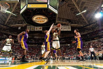 SEATTLE - FEBRUARY 24:  Mickael Gelabale #15 of the Seattle SuperSonics looks to pass over Coby Karl #11 of the Los Angeles Lakers during the game on February 24, 2008 at Key Arena in Seattle, Washington.  The Lakers won 111-91.  NOTE TO USER: User expressly acknowledges and agrees that, by downloading and/or using this Photograph, user is consenting to the terms and conditions of the Getty Images License Agreement. (Photo by Otto Greule Jr/Getty Images)