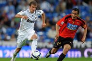 MADRID, SPAIN - MAY 24: Rafael van der Vaart (L) of Real Madrid controls the ball flanked by Juan Arango of Mallorca during the La Liga match between Real Madrid and Mallorca at the Santiago Bernabeu Stadium on May 24, 2009 in Madrid, Spain. Real Madrid lost the match 3-1. (Photo by Jasper Juinen/Getty Images)
