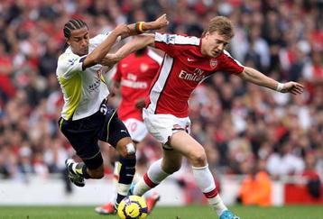 LONDON, ENGLAND - OCTOBER 31:  Nicklas Bendtner of Arsenal is challenged by Benoit Assou-Ekotto of Tottenham Hotspur during the Barclays Premier League match between Arsenal and Tottenham Hotspur at the Emirates Stadium on October 31, 2009 in London, England.  (Photo by Shaun Botterill/Getty Images)