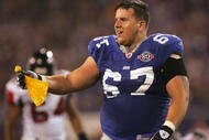 EAST RUTHERFORD, NJ - NOVEMBER 21: Guard Chris Snee #67 of the New York Giants looses his helmet and catches the flag on a penalty against the Atlanta Falcons in the third quarter at Giants Stadium on November 21, 2004 in East Rutherford, New Jersey. The Falcons defeated the Giants 14-10. (Photo by Harry How/Getty Images)