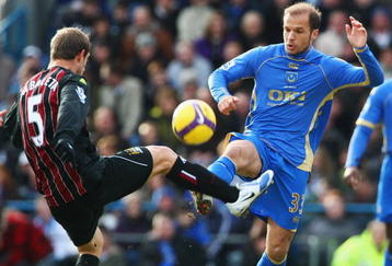 PORTSMOUTH, UNITED KINGDOM - FEBRUARY 14:  Angelos Basinas (R) of Portsmouth competes for the ball with Pablo Zabaleta (L) of Manchester City during the Barclays Premier League match between Portsmouth and Manchester City at Fratton Park on February 14, 2009 in London, England.  (Photo by Phil Cole/Getty Images)
