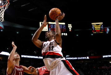 PORTLAND, OR - OCTOBER 27:  LaMarcus Aldridge #12 of the Portland Trail Blazers shoots over Carl Landry #14 of the Houston Rockets during the season opener on October 27, 2009 at the Rose Garden in Portland, Oregon. NOTE TO USER: User expressly acknowledges and agrees that, by downloading and or using this Photograph, user is consenting to the terms and conditions of the Getty Images License Agreement.  (Photo by Jonathan Ferrey/Getty Images)