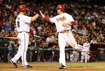 PHOENIX - AUGUST 10: Mark Reynolds #27 of the Arizona Diamondbacks celebrates at home plate with Chad Tracy #18 after scoring a run in the second inning against the New York Mets at Chase Field on August 10, 2009 in Phoenix, Arizona. (Photo by Christian Petersen/Getty Images)