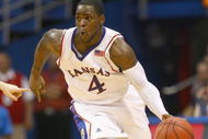 LAWRENCE, KANSAS - FEBRUARY 7:  Sherron Collins #4 of the Kansas Jayhawks drives the ball downcourt against the Oklahoma State Cowboys during the game at Allen Fieldhouse on February 7, 2009 in Lawrence, Kansas. (Photo by: Jamie Squire/Getty Images)