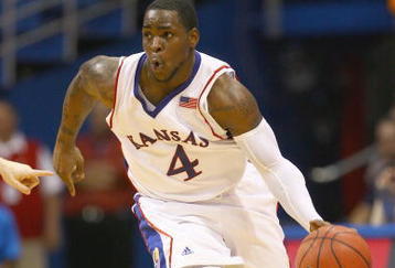 LAWRENCE, KANSAS - FEBRUARY 7:  Sherron Collins #4 of the Kansas Jayhawks drives the ball downcourt against the Oklahoma State Cowboys during the game at Allen Fieldhouse on February 7, 2009 in Lawrence, Kansas. (Photo by: Jamie Squire/Getty Images)