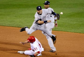 PHILADELPHIA - NOVEMBER 02:  Derek Jeter #2 of the New York Yankees turns a successful double play over Carlos Ruiz #51 in the bottom of the eighth inning against the Philadelphia Phillies in Game Five of the 2009 MLB World Series at Citizens Bank Park on November 2, 2009 in Philadelphia, Pennsylvania.  (Photo by Al Bello/Getty Images)