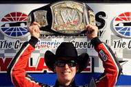 FORT WORTH, TX - NOVEMBER 07:  Kyle Busch, driver of the #18 Z-Line Designs/WWE Smackdown Toyota,  hoist a replica of the WWE world championship belt on victory lane after winning the NASCAR Nationwide Series O'Reilly Challenge at Texas Motor Speedway on November 7, 2009 in Fort Worth, Texas.  (Photo by John Harrelson/Getty Images for NASCAR)