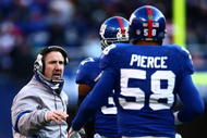 EAST RUTHERFORD, NJ - JANUARY 11:  Defensive corrdinator Steve Spagnuolo of the New York Giants talks with Aaron Pierce #58 during a break in play against the Philadelphia Eagles during the NFC Divisional Playoff Game on January 11, 2009 at Giants Stadium in East Rutherford, New Jersey.  (Photo by Chris McGrath/Getty Images)
