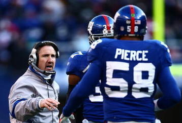 EAST RUTHERFORD, NJ - JANUARY 11:  Defensive corrdinator Steve Spagnuolo of the New York Giants talks with Aaron Pierce #58 during a break in play against the Philadelphia Eagles during the NFC Divisional Playoff Game on January 11, 2009 at Giants Stadium in East Rutherford, New Jersey.  (Photo by Chris McGrath/Getty Images)