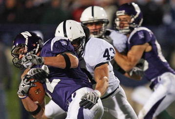 EVANSTON, IL - OCTOBER 31: Andrew Brewer #12 of the Northwestern Wildcats is tackled by Josh Hull #43 of the Penn State Nittany Lions at Ryan Field on October 31, 2009 in Evanston, Illinois. Penn State defeated Northwestern 34-13. (Photo by Jonathan Daniel/Getty Images)
