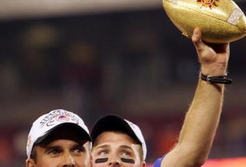 GLENDALE, AZ - JANUARY 1:  Head coach Chris Petersen of the Boise State Broncos holds up the Fiesta Bowl football after defeating the Oklahoma Sooners 43-42 at the Tostito's Fiesta Bowl against the Boise State Broncos at University of Phoenix Stadium January 1, 2007 in Glendale, Arizona.  (Photo by Jonathan Ferrey/Getty Images)
