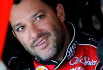 FONTANA, CA - OCTOBER 10:  Tony Stewart (L), driver of the #14 Office Depot/Old Spice Chevrolet, talks with Juan Pablo Montoya (R), driver of the #42 Target Chevrolet, during practice for the NASCAR Sprint Cup Series Pepsi 500 at Auto Club Speedway on October 10, 2009 in Fontana, California.  (Photo by Rusty Jarrett/Getty Images for NASCAR)