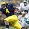 ANN ARBOR, MI - OCTOBER 25: Brandon Minor #4 of the Michigan Wolverines tries to get around the tackle of Brandon Long #47 of the Michigan State Spartans during a third quarter run on October 25, 2008 at Michigan Stadium in Ann Arbor, Michigan. Michigan State won the game 35-21. (Photo by Gregory Shamus/Getty Images)