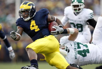 ANN ARBOR, MI - OCTOBER 25:  Brandon Minor #4 of the Michigan Wolverines tries to get around the tackle of Brandon Long #47 of the Michigan State Spartans during a third quarter run on October 25, 2008 at Michigan Stadium in Ann Arbor, Michigan. Michigan State won the game 35-21. (Photo by Gregory Shamus/Getty Images)