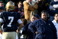 SOUTH BEND, IN - OCTOBER 17: Head coach Charlie Weis of the Notre Dame Fighting Irish looks at quarterback Jimmy Clausen #7 during the second quarter against the USC Trojans at Notre Dame Stadium on October 17, 2009 in South Bend, Indiana. (Photo by Jonathan Daniel/Getty Images)