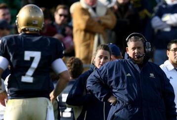 SOUTH BEND, IN - OCTOBER 17: Head coach Charlie Weis of the Notre Dame Fighting Irish looks at quarterback Jimmy Clausen #7 during the second quarter against the USC Trojans at Notre Dame Stadium on October 17, 2009 in South Bend, Indiana. (Photo by Jonathan Daniel/Getty Images)