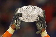 MIAMI - JANUARY 08: Brandon Spikes #51 of the Florida Gators holds up the winning trophy after the FedEx BCS National Championship Game against the Oklahoma Sooners at Dolphin Stadium on January 8, 2009 in Miami, Florida. (Photo by Eliot J. Schechter/Getty Images)