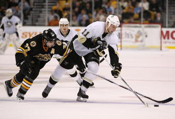 BOSTON - NOVEMBER 10:  Jordan Staal #11 of the Pittsburgh Penguins tries to keep the puck from Patrice Bergeron #37 of the Boston Bruins on November 10, 2009 at the TD Garden in Boston, Massachusetts. The Bruins defeated the Penguins 3-0.  (Photo by Elsa/Getty Images)