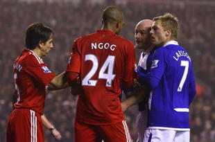 LIVERPOOL, ENGLAND - NOVEMBER 09:  David Ngog of Liverpool is confronted by Lee Carsley of Birmingham City after he won his side a penalty kick during the Barclays Premier League match between Liverpool and Birmingham City at Anfield on November 9, 2009 in Liverpool, England.  (Photo by Alex Livesey/Getty Images)