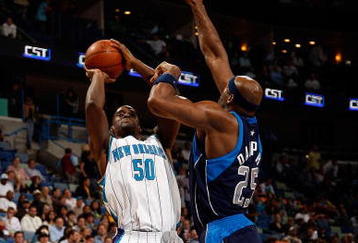 NEW ORLEANS - NOVEMBER 04:  Emeka Okafor #50 of the New Orleans Hornets makes a shot over Erick Dampier #25 of the  Dallas Mavericks at New Orleans Arena on November 4, 2009 in New Orleans, Louisiana.  The Hornets defeated the Mavericks 114-107.  NOTE TO USER: User expressly acknowledges and agrees that, by downloading and or using this photograph, User is consenting to the terms and conditions of the Getty Images License Agreement.  (Photo by Chris Graythen/Getty Images)