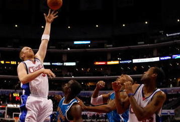 LOS ANGELES, CA - NOVEMBER 09:  Chris Kaman #35 of the Los Angeles Clippers shoots over Emeka Okafor #50 of the New Orleans Hornets in the first half at Staples Center on November 9, 2009 in Los Angeles, California. The Hornets defeated the Clippers 112-84. NOTE TO USER: User expressly acknowledges and agrees that, by downloading and/or using this Photograph, user is consenting to the terms and conditions of the Getty Images License Agreement.  (Photo by Jeff Gross/Getty Images)