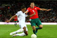 LONDON, ENGLAND - OCTOBER 14:  Glen Johnson of England tackles Aleksandr Yurevich of Belarus during the FIFA 2010 World Cup Qualifying Group 6 match between England and Belarus at Wembley Stadium on October 14, 2009 in London, England.  (Photo by Phil Cole/Getty Images)