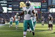 FOXBORO, MA - NOVEMBER 08:  Ricky Williams #34 of the Miami Dolphins celebrates his touchdown in the second quarter agianst the New England Patriots on November 8, 2009 at Gillette Stadium in Foxboro, Massachusetts.  (Photo by Elsa/Getty Images)