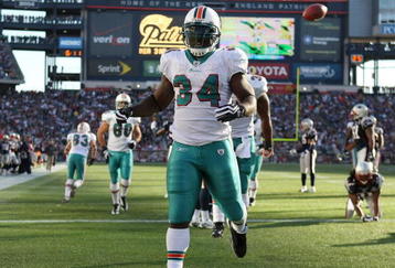 FOXBORO, MA - NOVEMBER 08:  Ricky Williams #34 of the Miami Dolphins celebrates his touchdown in the second quarter agianst the New England Patriots on November 8, 2009 at Gillette Stadium in Foxboro, Massachusetts.  (Photo by Elsa/Getty Images)
