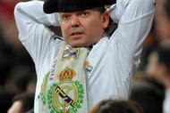 MADRID, SPAIN - NOVEMBER 10:  Real Madrid fan 'Tonin el Torero' reacts as he watches his team play during the Copa del Rey fourth round, second leg match between Real Madrid and AD Alcorcon at the Estadio Santiago Bernabeu on November 10, 2009 in Madrid, Spain. Real Madrid won the match 1-0 but got eliminated from the Copa del Rey by the third Division Spanish League team losing 4-1 on aggregate.  (Photo by Jasper Juinen/Getty Images)