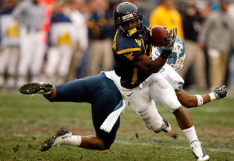 CHARLOTTE, NC - DECEMBER 27:  Trimane Goddard #31 of the North Carolina Tar Heels misses a tackle on Jock Sanders #9 of the West Virginia Mountaineers during the Meineke Car Care Bowl on December 27, 2008 at Bank of America Stadium in Charlotte, North Carolina.  (Photo by Streeter Lecka/Getty Images)