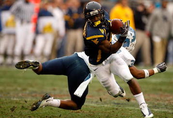 CHARLOTTE, NC - DECEMBER 27:  Trimane Goddard #31 of the North Carolina Tar Heels misses a tackle on Jock Sanders #9 of the West Virginia Mountaineers during the Meineke Car Care Bowl on December 27, 2008 at Bank of America Stadium in Charlotte, North Carolina.  (Photo by Streeter Lecka/Getty Images)