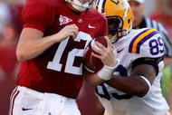 TUSCALOOSA, AL - NOVEMBER 07:  Quarterback Greg McElroy #12 of the Alabama Crimson Tide rushes upfield against Lavar Edwards #89 of the Louisiana State University Tigers at Bryant-Denny Stadium on November 7, 2009 in Tuscaloosa, Alabama.  (Photo by Kevin C. Cox/Getty Images)