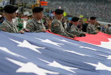 FORT WORTH, TX - NOVEMBER 08:  Soldiers in the U.S. Army from Fort Hood hold the flag during pre race ceremonies prior to the start of the NASCAR Sprint Cup Series Dickies 500 at Texas Motor Speedway on November 8, 2009 in Fort Worth, Texas.  (Photo by Tom Pennington/Getty Images for NASCAR)