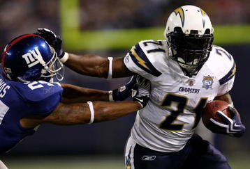EAST RUTHERFORD, NJ - NOVEMBER 08:  LaDainian Tomlinson #21 of the San Diego Chargers fends off Terrell Thomas #24 of the the New York Giants on November 8, 2009 at Giants Stadium in East Rutherford, New Jersey.  (Photo by Chris McGrath/Getty Images)