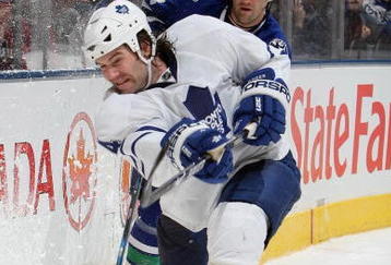 TORONTO - FEBRUARY 21:  Jeff Finger #4 of the Toronto Maple Leafs shoots the puck against Pavol Demitra #38 of Vancouver Canucks during the game against the at Air Canada Centre on February 21, 2009 in Toronto, Ontario. (Photo by Dave Sandford/Getty Images)