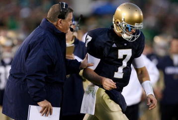 SOUTH BEND, IN - OCTOBER 17: Head coach Charlie Weis of the Notre Dame Fighting Irish speaks to quarterback Jimmy Clausen #7 during the fourth quarter against the USC Trojans at Notre Dame Stadium on October 17, 2009 in South Bend, Indiana. USC won the game 34-27. (Photo by Jonathan Daniel/Getty Images)