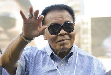 NEW YORK - AUGUST 06:  Boxing great Muhammad Ali  waves to the crowd during a ceremony honoring him with the 'Six Star Diamond Award' from the American Academy of Hospitality Sciences before the AL baseball game between the Boston Red Sox and the New York Yankees at Yankee Stadium on August 6, 2009 in New York, New York.  (Photo by Paul Bereswill/Getty Images)