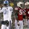 FOXBORO - OCTOBER 18:  Vince Young #10 of the Tennessee Titans leaves the field as Pierre Woods #58 and Mike Wright #99 of the New England Patriots converse at Gillette Stadium on October 18, 2009 in Foxboro, Massachusetts. The Patriots won 59-0. (Photo by Jim Rogash/Getty Images)