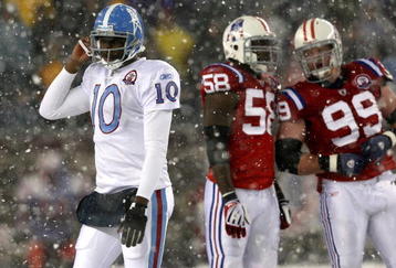 FOXBORO - OCTOBER 18:  Vince Young #10 of the Tennessee Titans leaves the field as Pierre Woods #58 and Mike Wright #99 of the New England Patriots converse at Gillette Stadium on October 18, 2009 in Foxboro, Massachusetts. The Patriots won 59-0. (Photo by Jim Rogash/Getty Images)