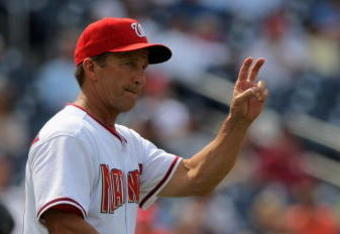WASHINGTON - AUGUST 06:  Manager Jim Riggleman #5 of the Washington Nationals heads to the mound and motions for the left hander from the bullpen to face the Florida Marlins at Nationals Park on August 6, 2009 in Washington, DC. The Nationals defeated the Marlins 12-8.  (Photo by Doug Pensinger/Getty Images)