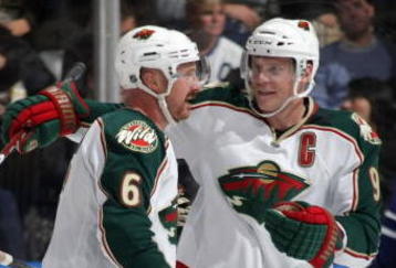 TORONTO - NOVEMBER 10: Mikko Koivu #9 of the Minnesota Wild congratulates teammate Greg Zanon #6 on his first goal of the season against the Toronto Maple Leafs at the Air Canada Centre on November 10, 2009 in Toronto, Ontario, Canada. (Photo by Bruce Bennett/Getty Images)