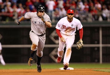 PHILADELPHIA - NOVEMBER 01:  Johnny Damon #18 (L) of the New York Yankees advances to third base after he stole second base in the top of the ninth inning against Pedro Feliz #7 of the Philadelphia Phillies in Game Four of the 2009 MLB World Series at Citizens Bank Park on November 1, 2009 in Philadelphia, Pennsylvania.  (Photo by Al Bello/Getty Images)
