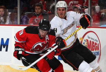 NEWARK, NJ - NOVEMBER 11:  Joffrey Lupul #14 of the Anaheim Ducks defends against Zach Parise #9 of the New Jersey Devils during their NHL game at the Prudential Center on November 11, 2009 in Newark, New Jersey.  (Photo by Jim McIsaac/Getty Images)