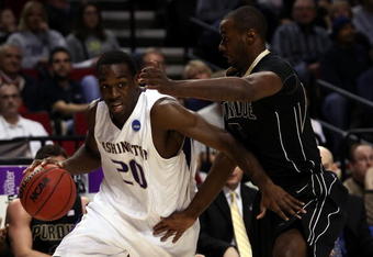 PORTLAND, OR - MARCH 21:  Quincy Pondexter #20 of the Washington Huskies drives on Keaton Grant #5 of the Purdue Boilermakers in the first half during the second round of the NCAA Division I Men's Basketball Tournament at the Rose Garden on March 21, 2009 in Portland, Oregon.  (Photo by Jonathan Ferrey/Getty Images)