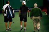 SHANGHAI, CHINA - OCTOBER 13: Andy Roddick of the United States leaves the court with ATP trainer Michael Novotny and ATP Supervisor Tom Barnes after retiring from his match against Stanilas Wawrinka of Switzerland on day three of the 2009 Shanghai ATP Masters 1000 at Qi Zhong Tennis Centre on October 13, 2009 in  (Photo by Matthew Stockman/Getty Images)