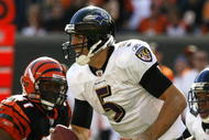 CINCINNATI - NOVEMBER 8: Quarterback Joe Flacco #5 of the Baltimore Ravens scrambles under pressure from Frank Walker #41 of the Cincinnati Bengals in their NFL game at Paul Brown Stadium November 8, 2009 in Cincinnati, Ohio. (Photo by John Sommers II/Getty Images)