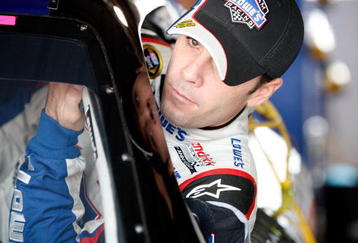 MARTINSVILLE, VA - OCTOBER 23:  Jimmie Johnson gets in the #48 Lowe's Chevrolet in the garage prior to practice for the NASCAR Sprint Cup Series TUMS Fast Relief 500 at Martinsville Speedway on October 23, 2009 in Martinsville, Virginia.  (Photo by Streeter Lecka/Getty Images)