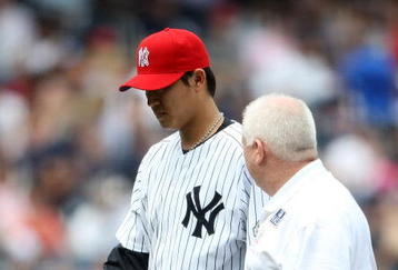 NEW YORK - JULY 04:  Chien-Ming Wang #40 of the New York Yankees leaves the game in the sixth inning with a strained right shoulder against the Toronto Blue Jays on July 4, 2009 at Yankee Stadium in the Bronx borough of New York City.  (Photo by Nick Laham/Getty Images)