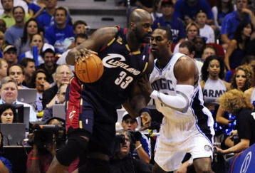 ORLANDO, FL - NOVEMBER 11:  Shaquille O'Neal #33 of the Cleveland Cavaliers posts up against Dwight Howard #12 of the Orlando Magic during the game on November 11, 2009 at Amway Arena in Orlando, Florida. NOTE TO USER: User expressly acknowledges and agrees that, by downloading and/or using this Photograph, user is consenting to the terms and conditions of the Getty Images License Agreement. (Photo by Sam Greenwood/Getty Images)